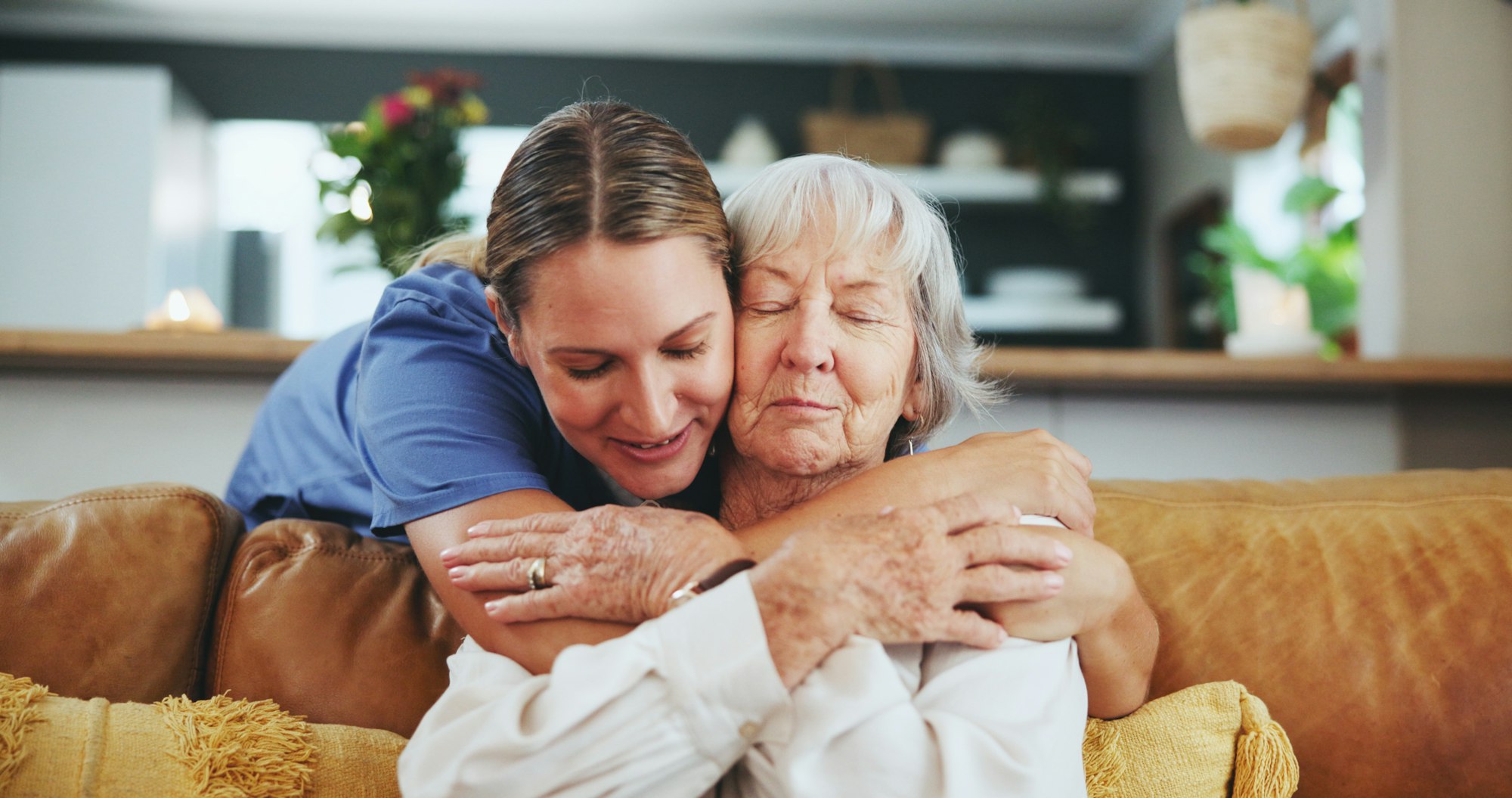 Happy woman, nurse and hug with senior patient in elderly care, love or nursing at retirement home.